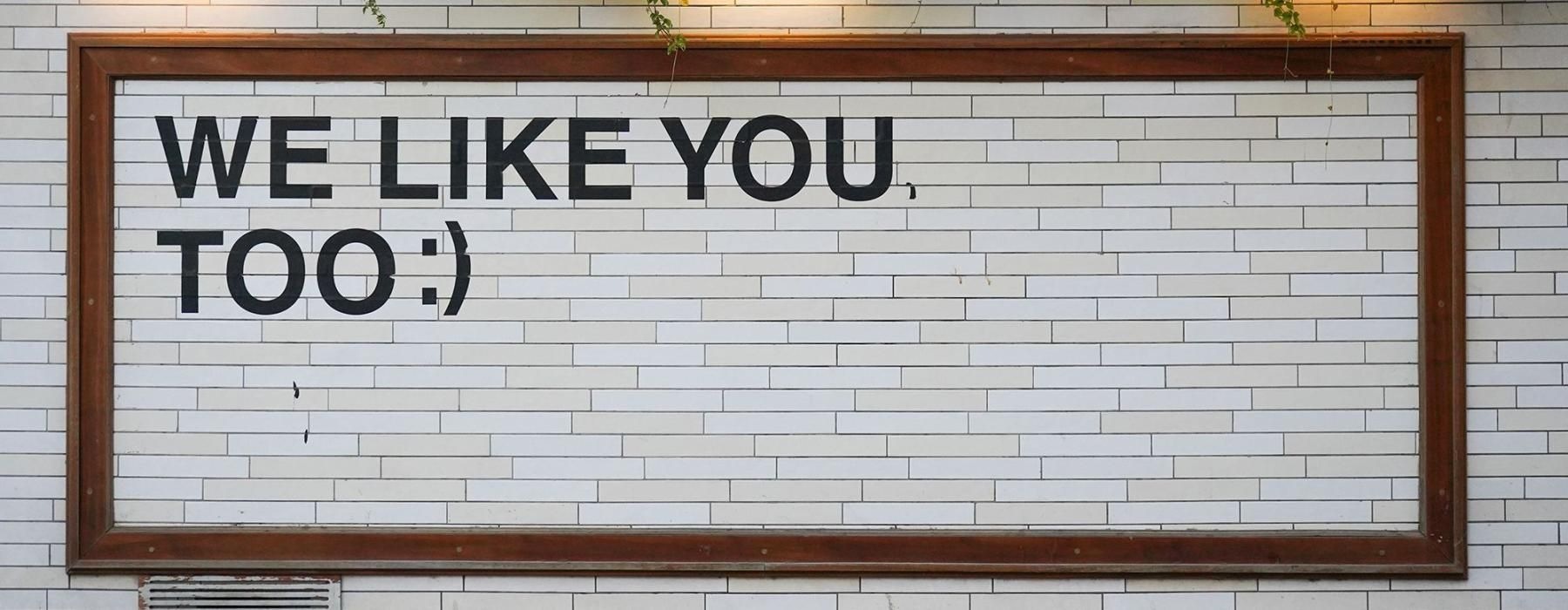 a sign on a tile wall that says, 