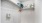 a white room with a shelf and a white wall