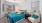 a bedroom with a bed and a fan